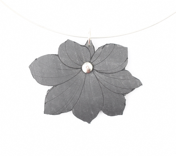 Recyled Jewellery: A Simple Wire Necklace featuring a large, dark grey flower pendant with six petals and a single pearl at the center, suspended on a thin, eco-friendly transparent wire. @ Reblack Shop
